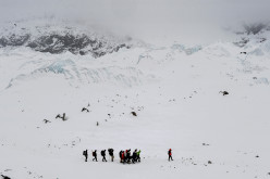 Rescuers carry an injured person to a medical tent moments after a wall of rock, snow and debris slammed into Everest Base Camp on April 25, 2015 killing at least 22 people. The avalanche was triggered by a powerful 7.8-magnitude earthquake that killed more than 8,000 people in the country. Rescue helicopters managed to reach the site about 18 hours after the avalanche as bad weather, aftershocks and fears of further avalanches rattled survivors. At the time of the disaster, the 5,364-meter-high Base Camp was teeming with hundreds of climbers and supporting teams who use the base to prepare their ascent to the peak of Mount Everest, the tallest mountain on Earth.