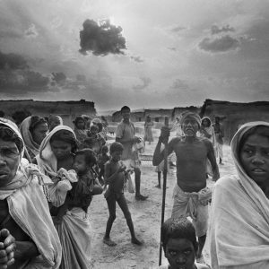 Famine and smallpox epidemic. Villagers come out of their huts to beg ...